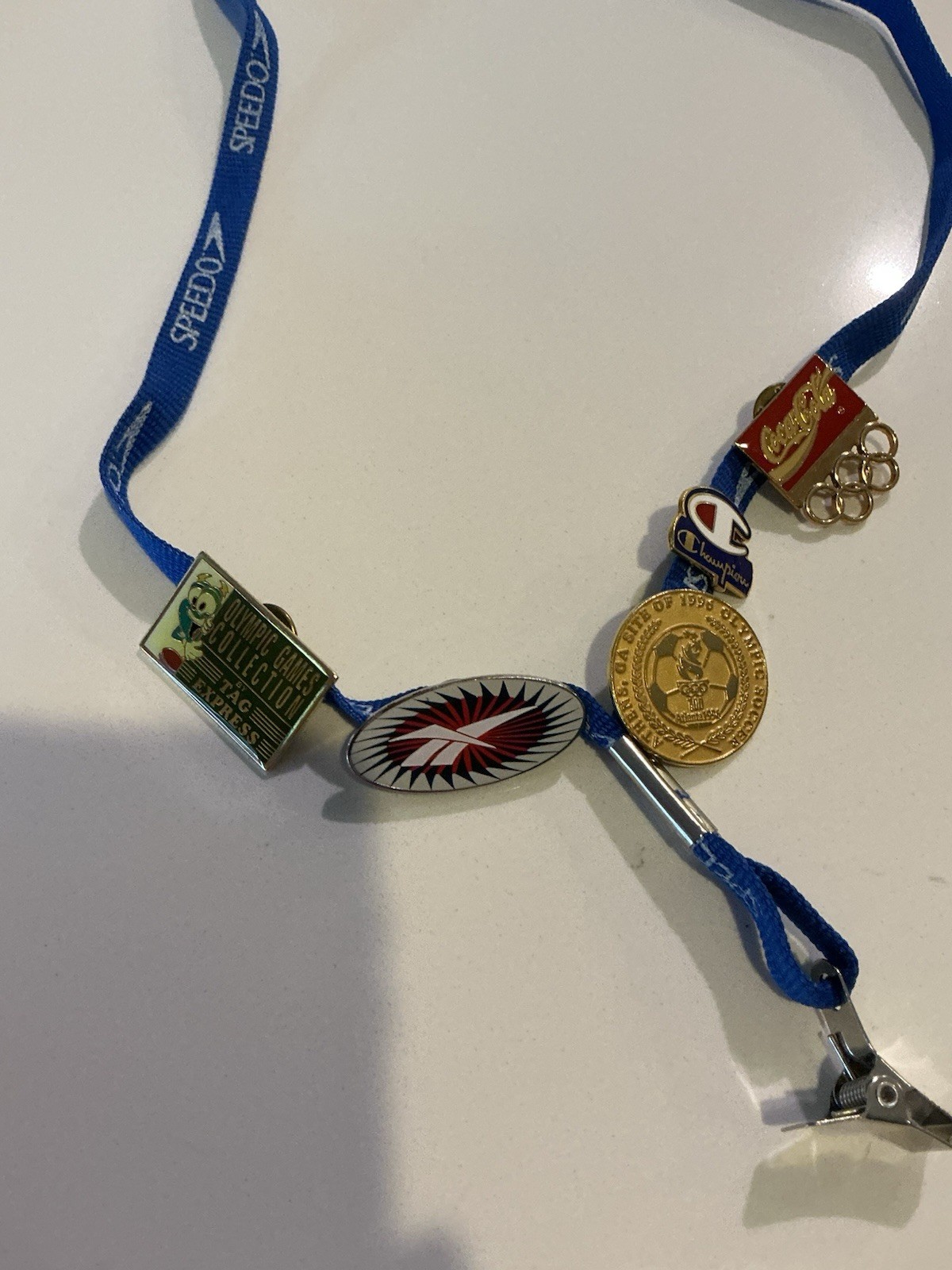 Vintage 1996 Atlanta Olympic Games collectible pin lot with Speedo lanyard.