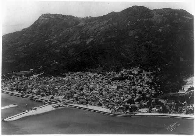 Aerial view,Cap Haitien,mountains,waterfronts,docks,piers,Haiti,E Peloux,1953