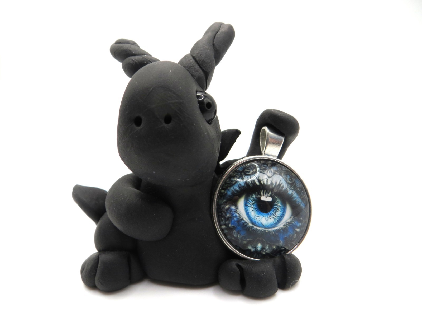 Black clay dragon with a large blue eye