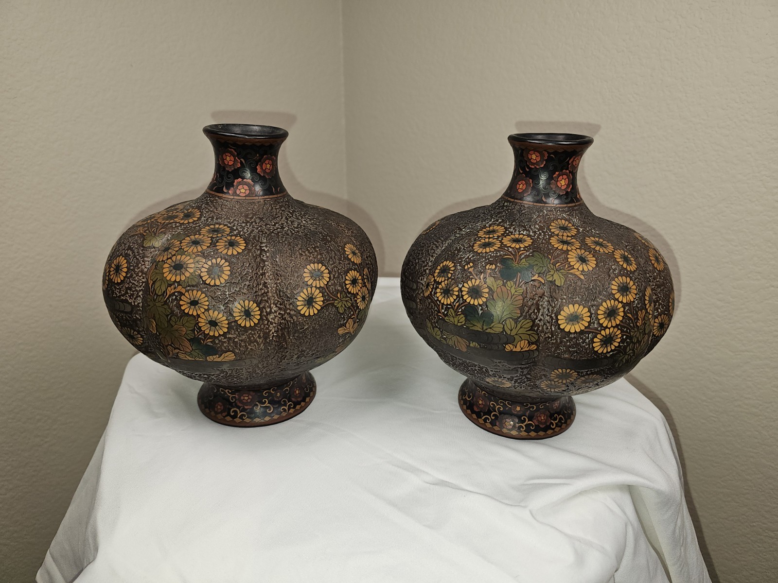 Matching pair of vintage Asian ceramic vases featuring rounded bodies