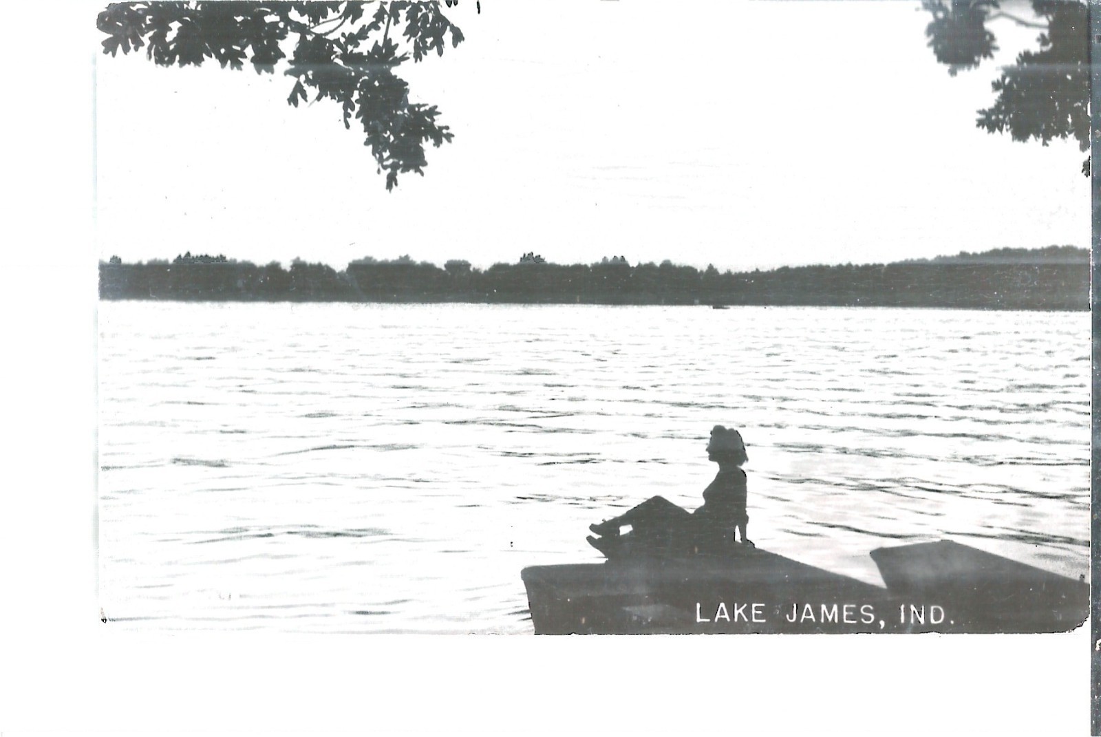 NICE RPPC VIEW OF A LADY SITTING ON THE DOCK AT LAKE JAMES, IN