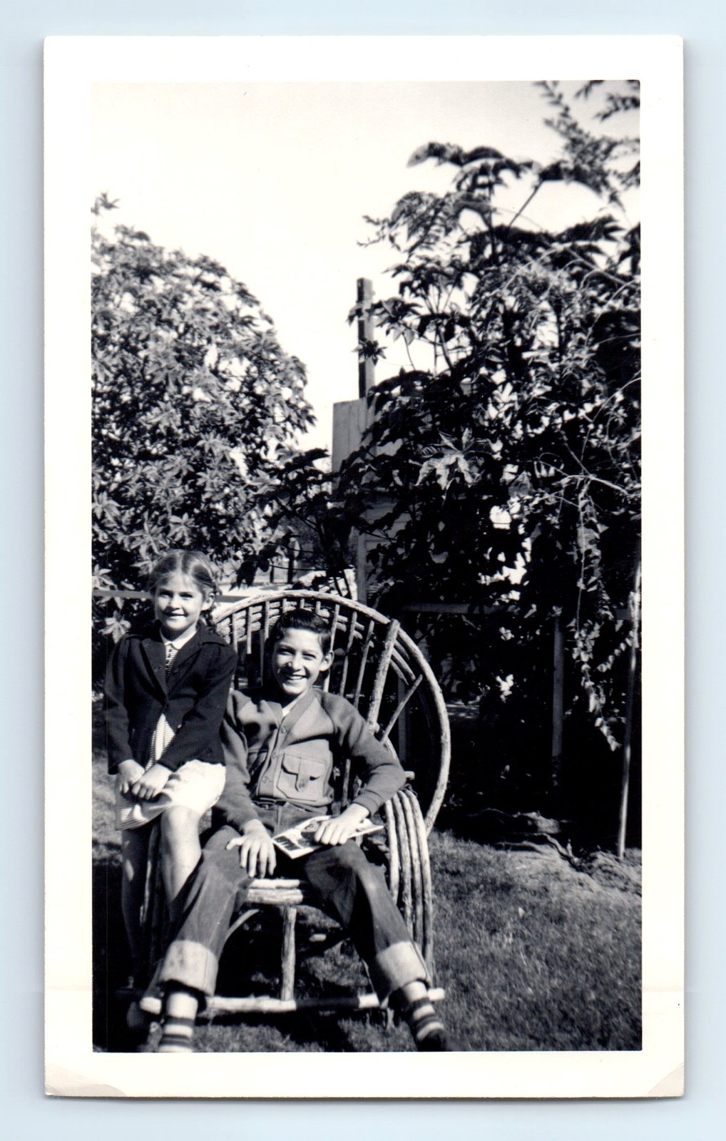 Old Vintage Photo BOY AND GIRL SITTING IN CHAIR BACKYARD ANTIQUE SNAPSHOT