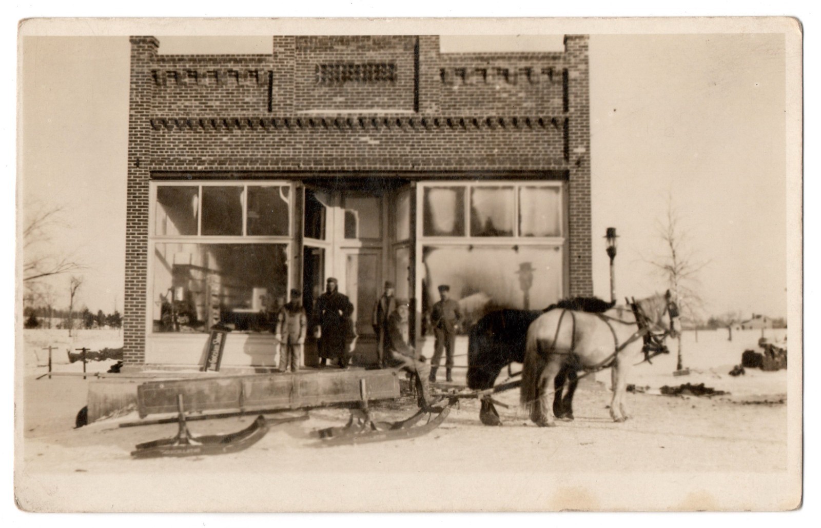 Vintage RPPC Winter Scene Horse Drawn Sleigh Brick Storefront Postcard