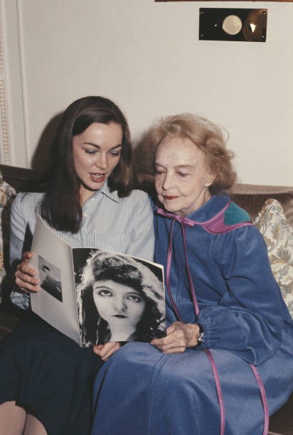 American actress Lillian Gish looks at old photographs of herself - Old Photo