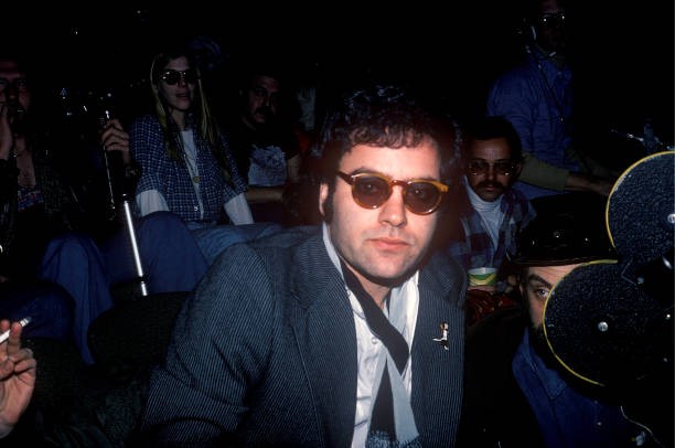 American film director Amos Poe seated among the audience at an un- Old Photo