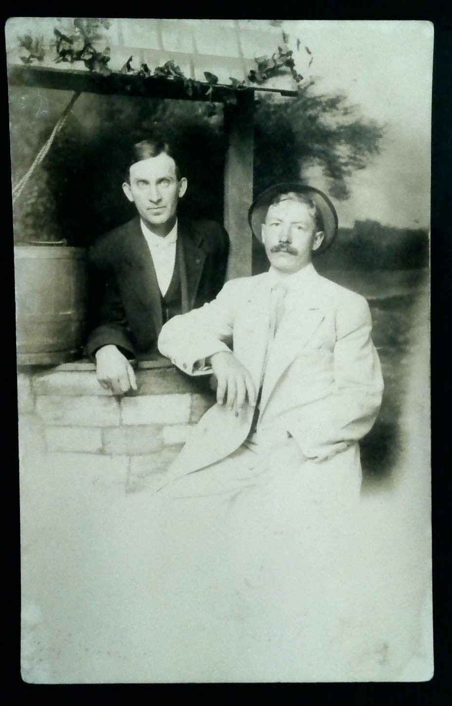 Vintage ARTURA Real Photo Postcard of Two Men by Well with Hat