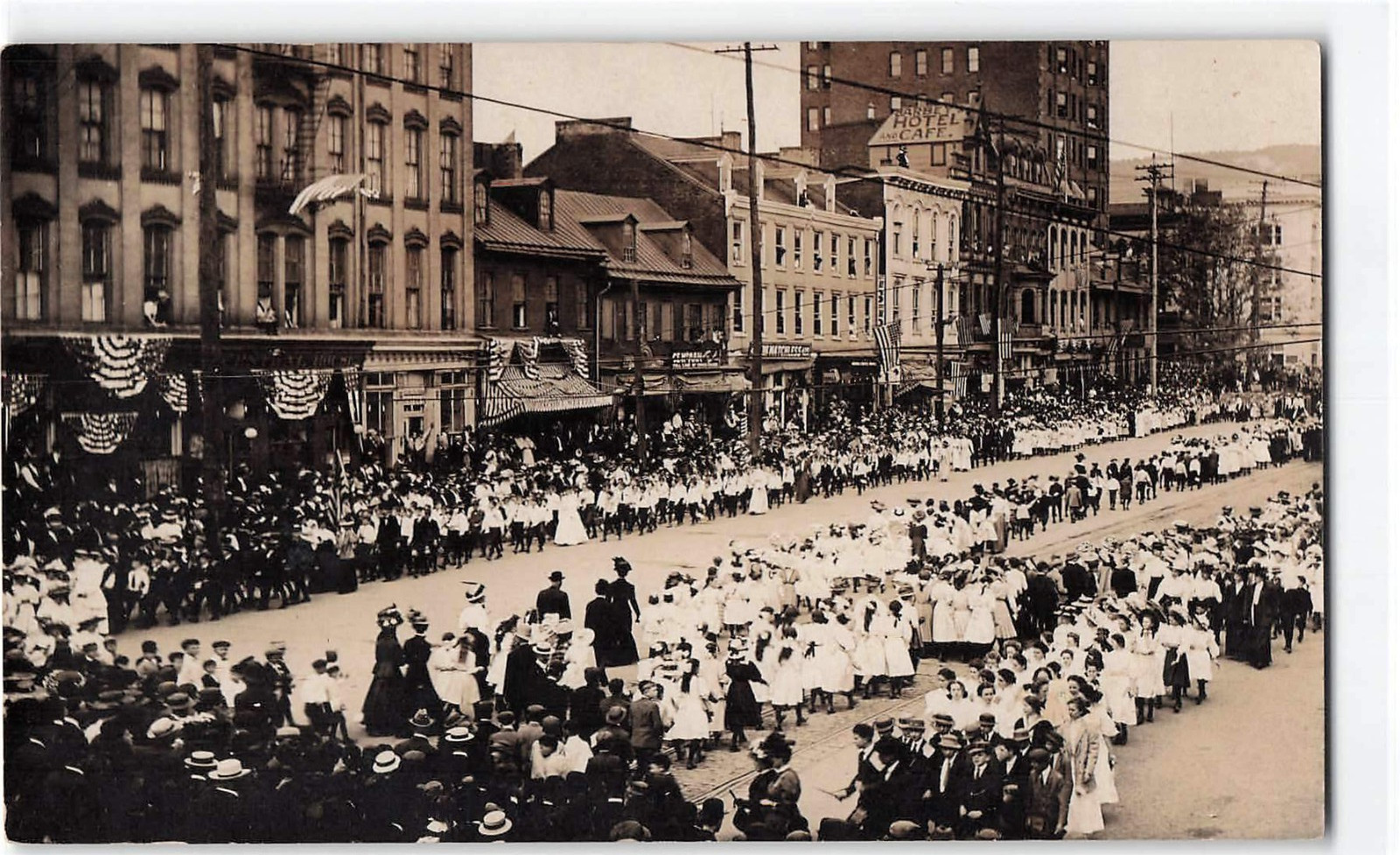 Early 1900's RPPC, Large Parade or Public Gathering Along a Busy Downtown Street