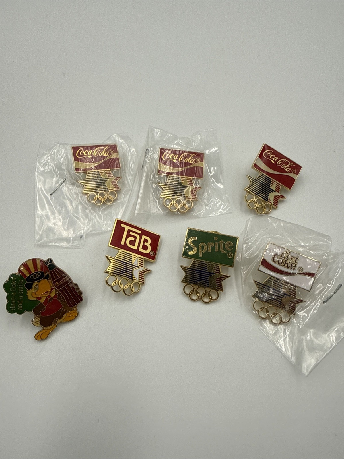 Lot of 7 LA Los Angeles 1984 Olympic Games Coca Cola Pins Mascot Sprite Coke