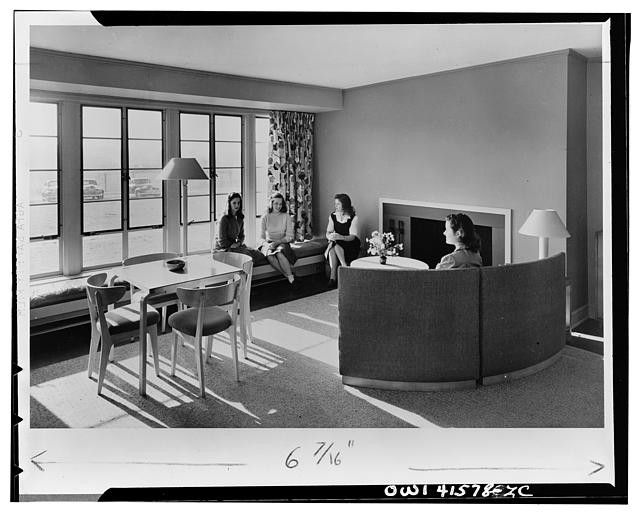 Photo:1940s Modern Living Room Women Indoor Seating Fireplace Large Window