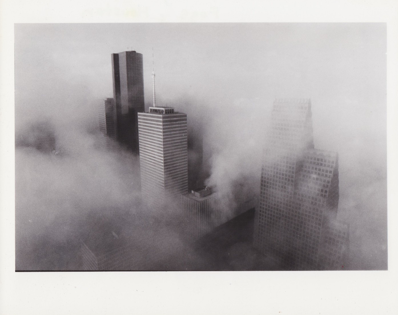 TYPE 1: 1988 Press Photo Aerial Skyscrapers rise above fog in downtown Houston