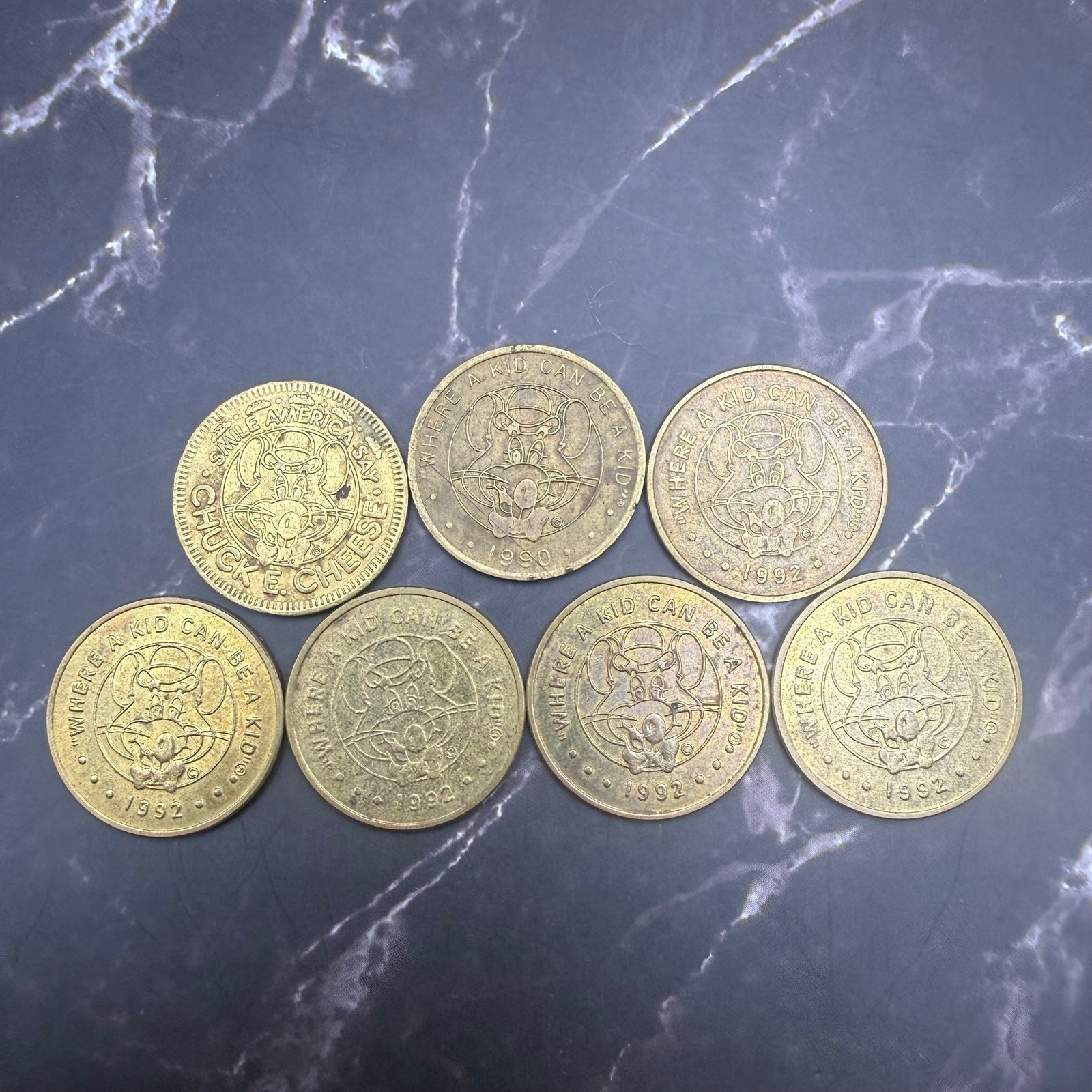7 Vintage Chuck E Cheese Tokens 1983 1990 1992 Arcade Animatronic Lot