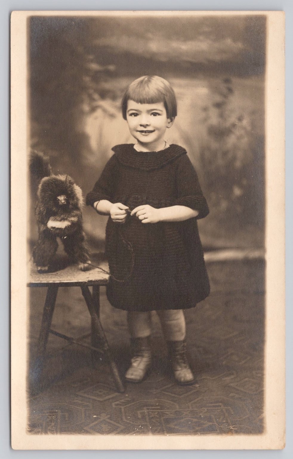 Vintage Real Photo Postcard of Girl with Toy Monkey by Artura