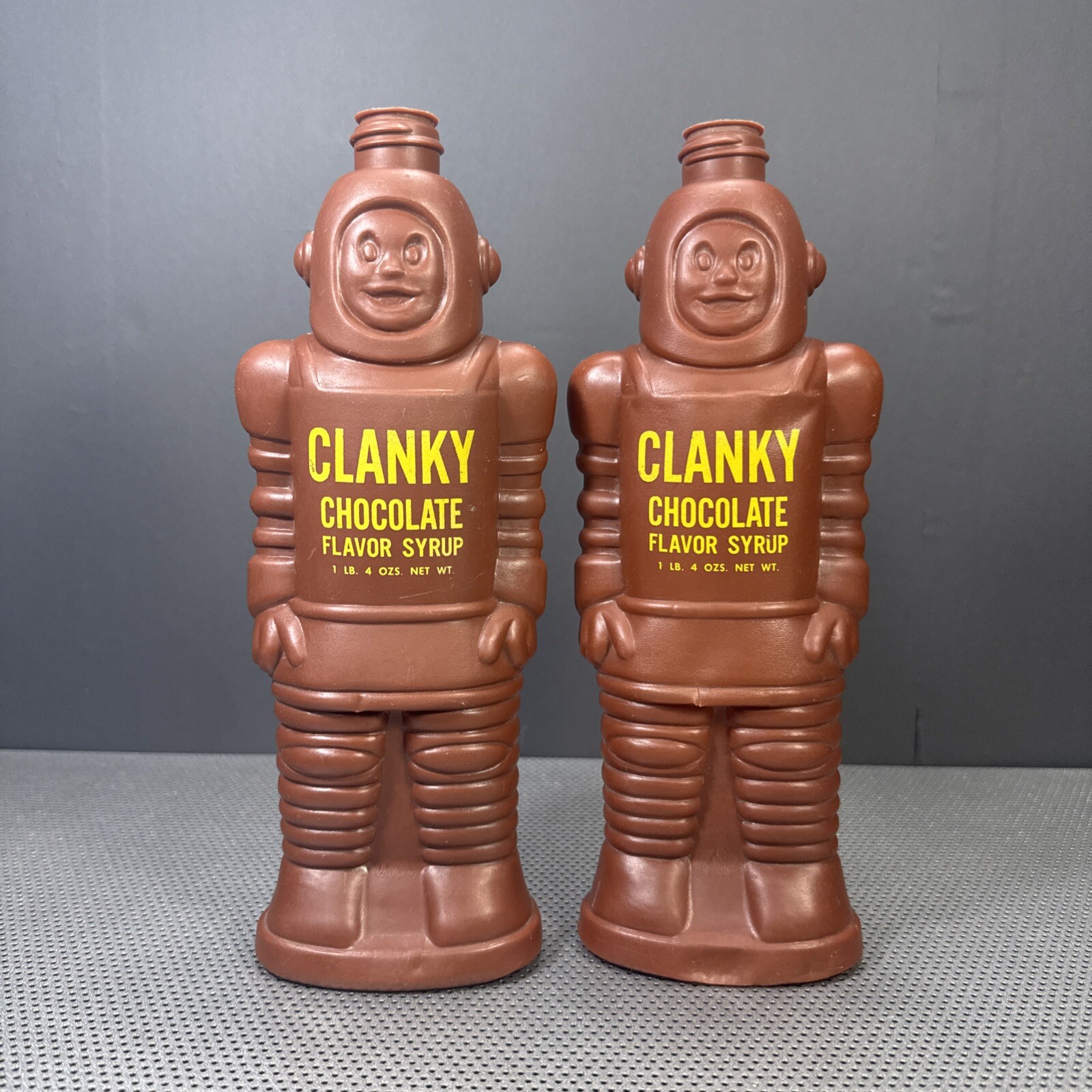 (2) Two Vintage 1963 Clanky Chocolate Flavored Syrup Robot Empty Bottles