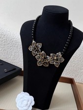 CHANEL Vintage Collection: Enamel Camellia necklace featuring a brass CC logo. picture