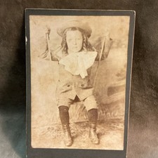 Victorian 1880s photograph boy on swing with long hair big bow disappointed look picture