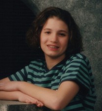 1990s Woman Short Curly Brown Hair Braces Smiling Leaning Marble Surface picture