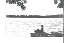 NICE RPPC VIEW OF A LADY SITTING ON THE DOCK AT LAKE JAMES, IN picture