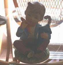 Porcelain Boy Figurine Sitting Holding Black Bag, Multicolor Matte, 1 Pack picture
