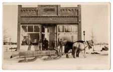 Vintage RPPC Winter Scene Horse Drawn Sleigh Brick Storefront Postcard picture