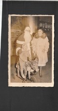 Antique real photo postcard Santa Claus w/ child on riding toy picture