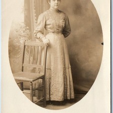 c1910s Young Woman RPPC Fashion Dress Standing Chair Portrait Postcard picture