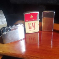 Lot of 4 Vintage Collectible Cigarette Lighters Zippo Continental L&M Winston picture