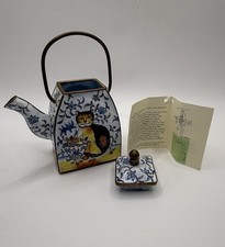 Miniature Square Shaped Enamel Teapot Featuring A Painted Cat Holding A Basket picture