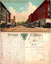 Albion NY. Bank Street East From Main St. Red Buildings Car Bike Postcard 57398 picture