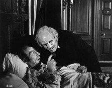 Alastair Sim as Scrooge listens to the words of a dying man 1951 Old Photo picture