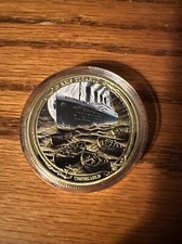 Gold RMS Titanic Coin That Has A Moonlight Picture And Life Boats picture