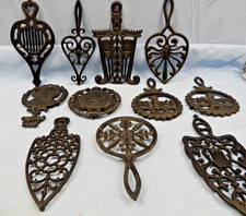 Lot of 11 Black Cast Iron Novelty Trivets, Assorted Designs. picture