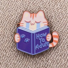 Pin - Kawaii Orange Tabby Cat Reading How To Adult Book, Funny Kitty Adulting picture