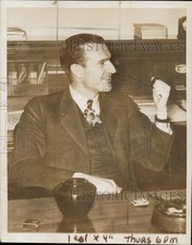 1939 Press Photo John D. Rockefeller, 3rd smokes a pipe in his office picture
