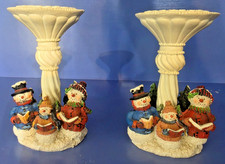 Pair of decorative Christmas candlesticks with group of snowman carolers at base picture